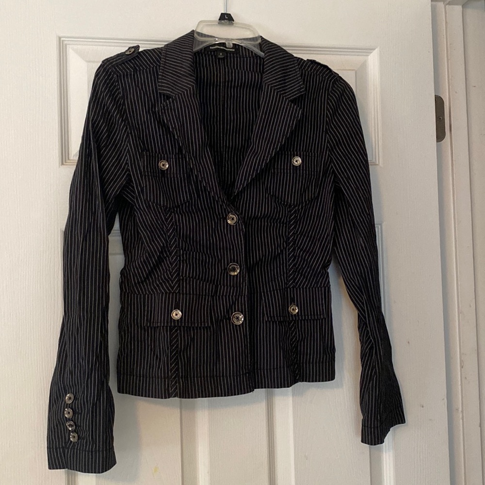 Black button up jacket with white pin strap detailing